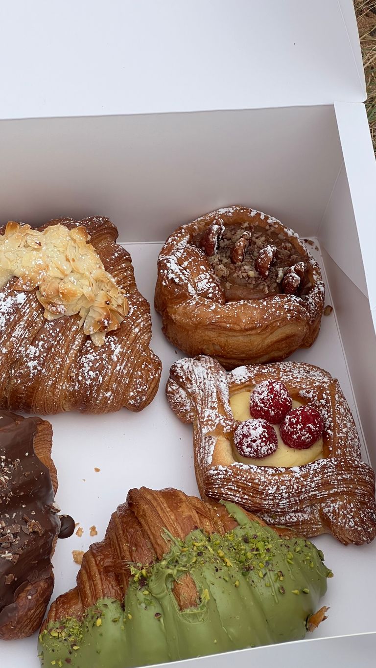 Box of assorted gourmet pastries including croissants and danishes, perfect for breakfast or brunch.