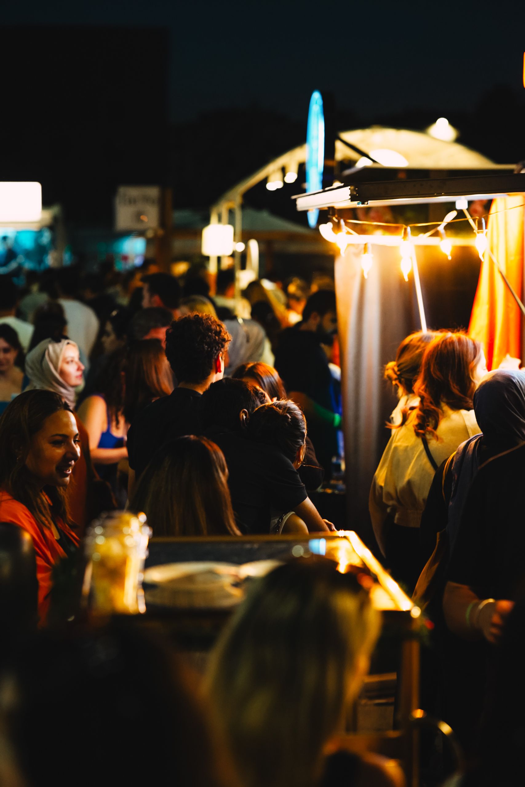 Bustling night market in Ankara filled with people enjoying street food and nightlife.
