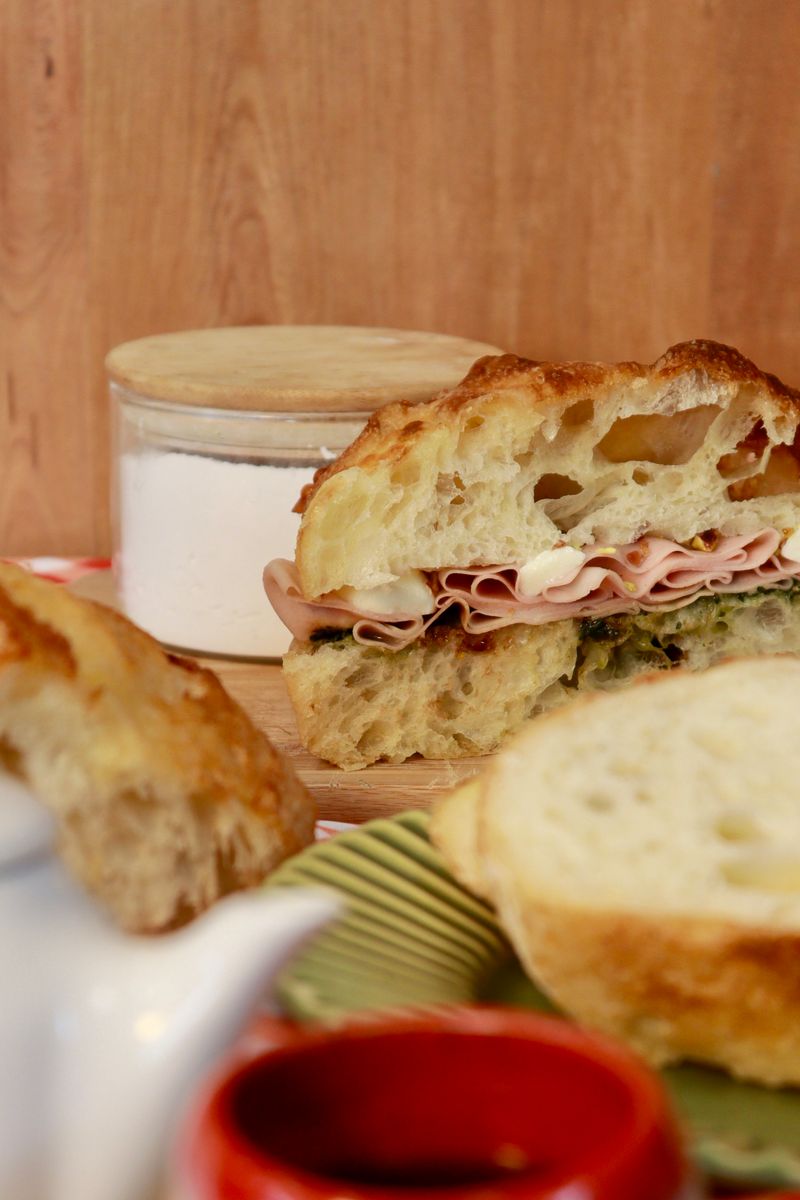 Close-up of a ham sandwich with rustic bread, rich layers, perfect for lunch.