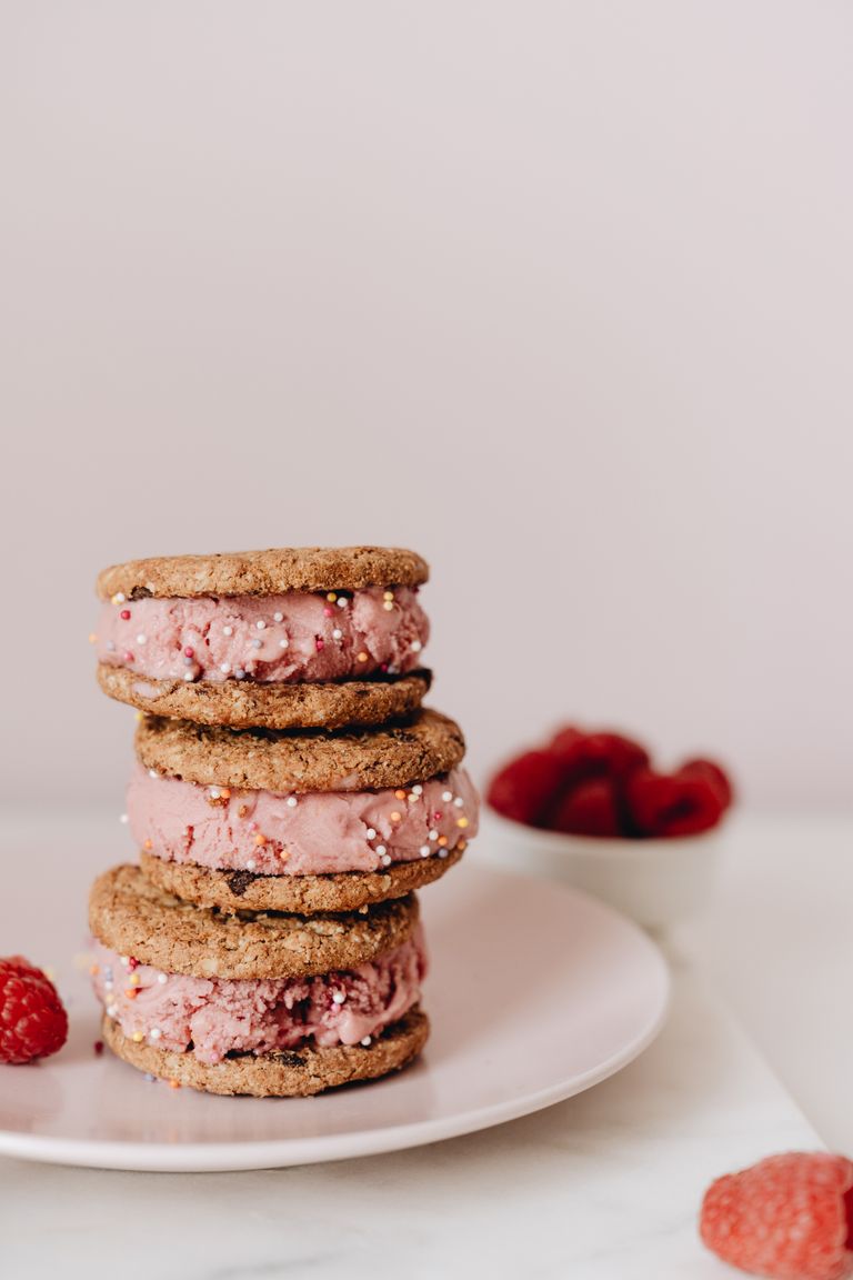 Close-up of stacked ice cream cookie sandwiches with raspberry filling.