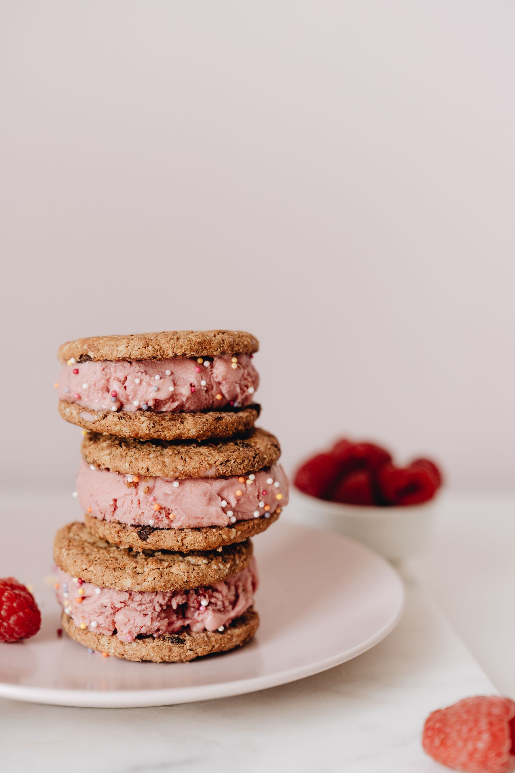 Close-up of stacked ice cream cookie sandwiches with raspberry filling.