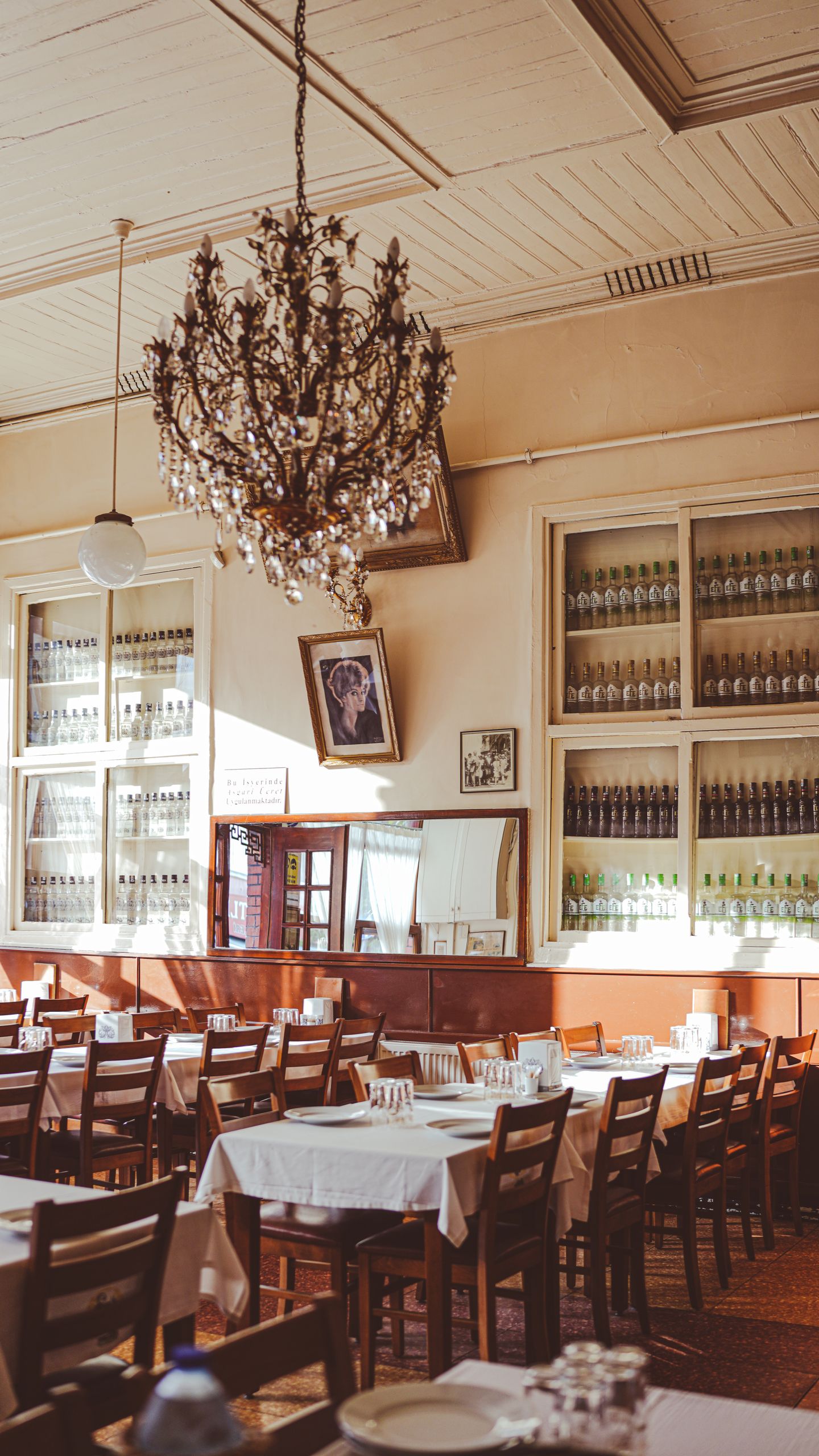 Cozy Istanbul restaurant featuring elegant chandeliers and classic table settings.
