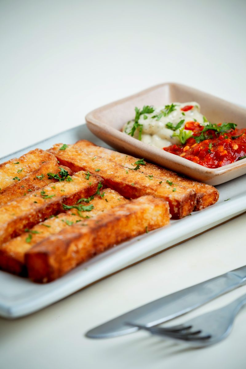 Crispy tofu sticks served with spicy red and creamy white dipping sauces.