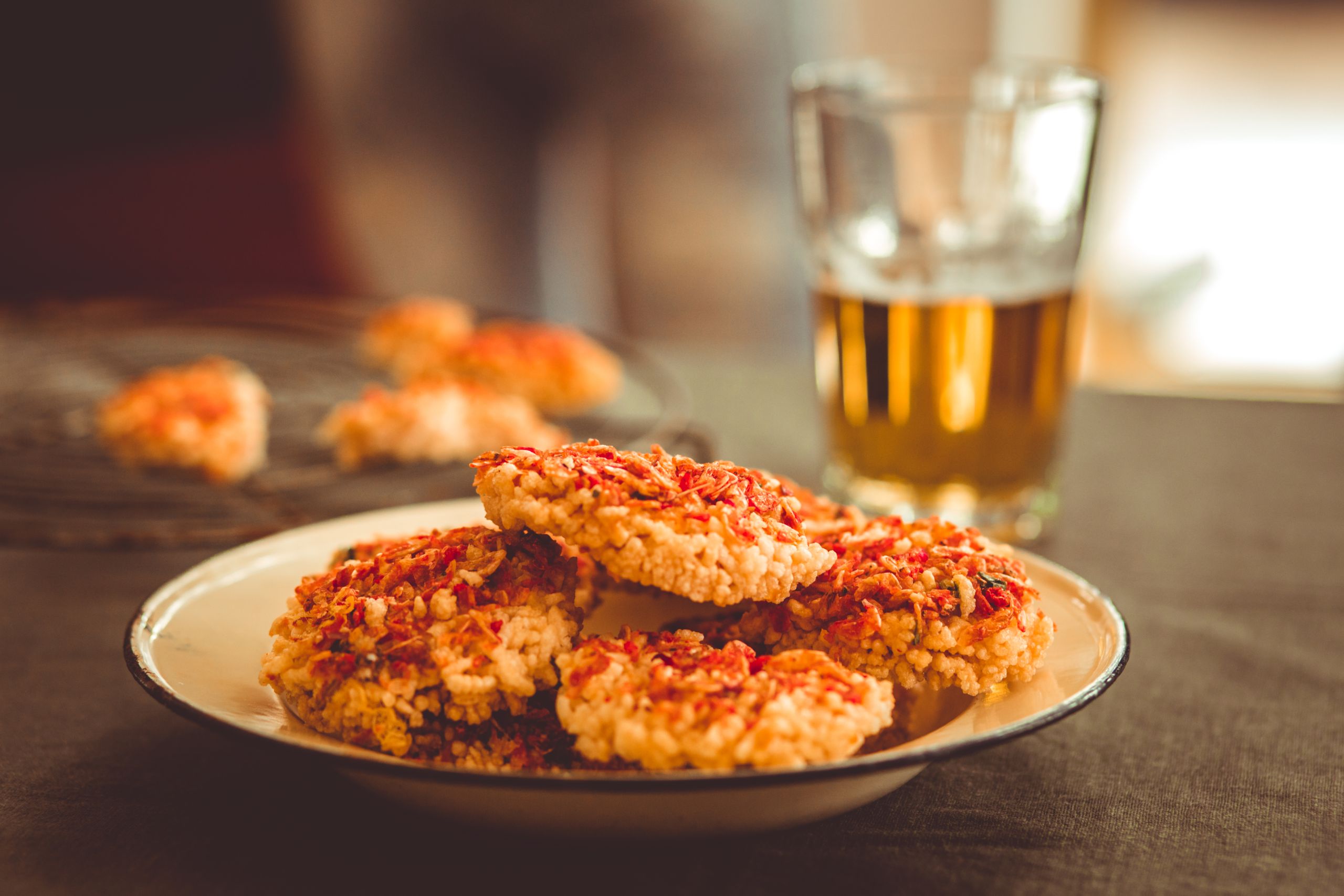 Delicious rice cakes topped with seasoning served with a cold drink, perfect for an appetizing meal.