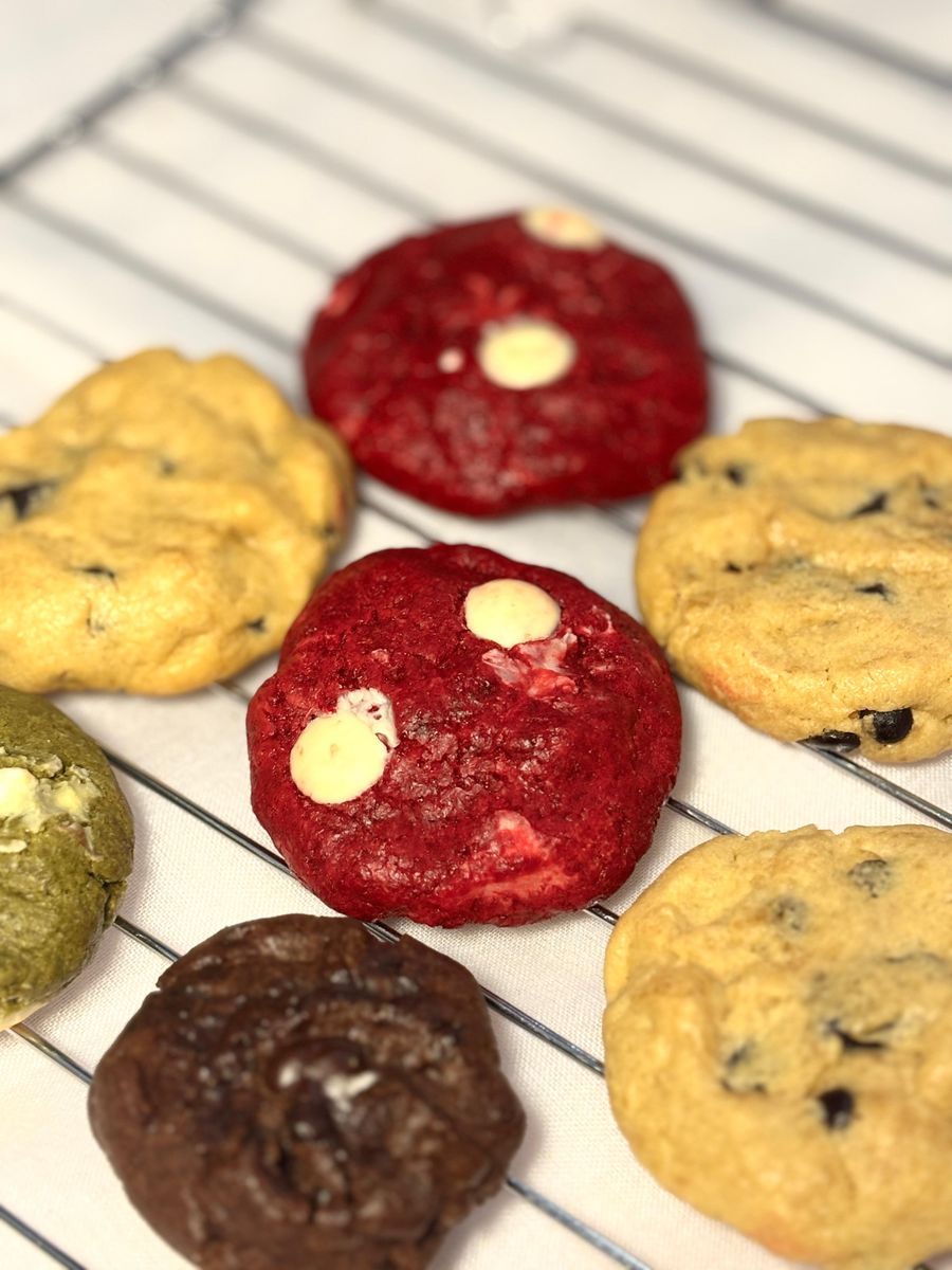 Delicious variety of cookies on a cooling rack showcasing different flavors.