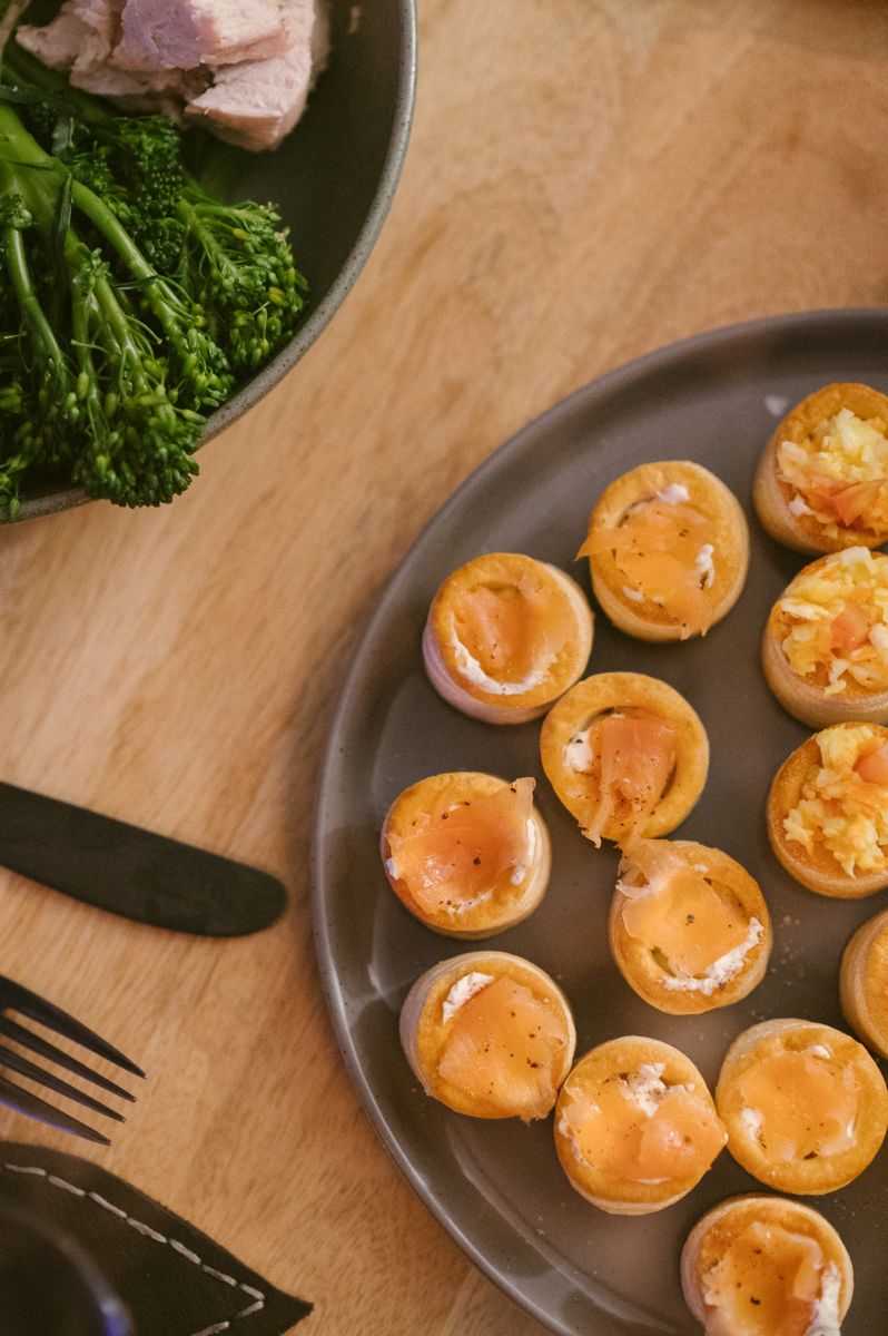 Elegant dinner table featuring smoked salmon bites and fresh broccoli.