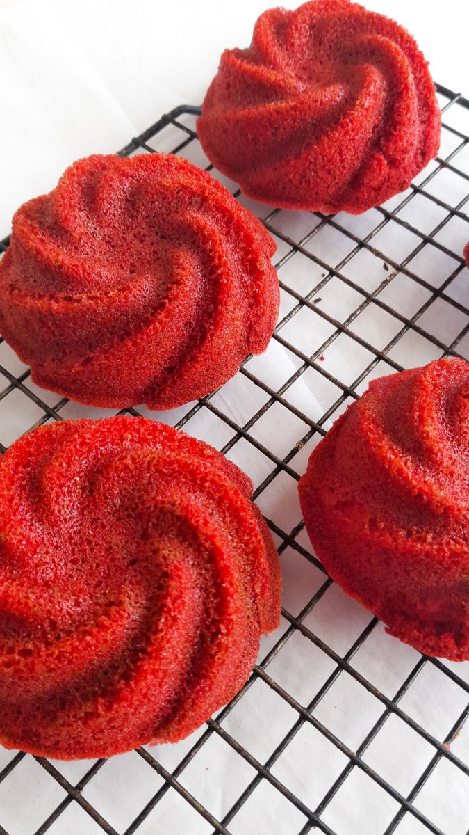 Fresh red velvet bundt cakes cooling on a wire rack, perfect for dessert enthusiasts.