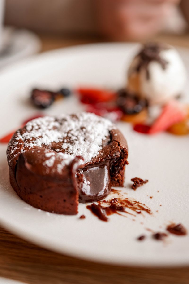Indulge in a gooey chocolate lava cake served with fresh berries and vanilla ice cream.