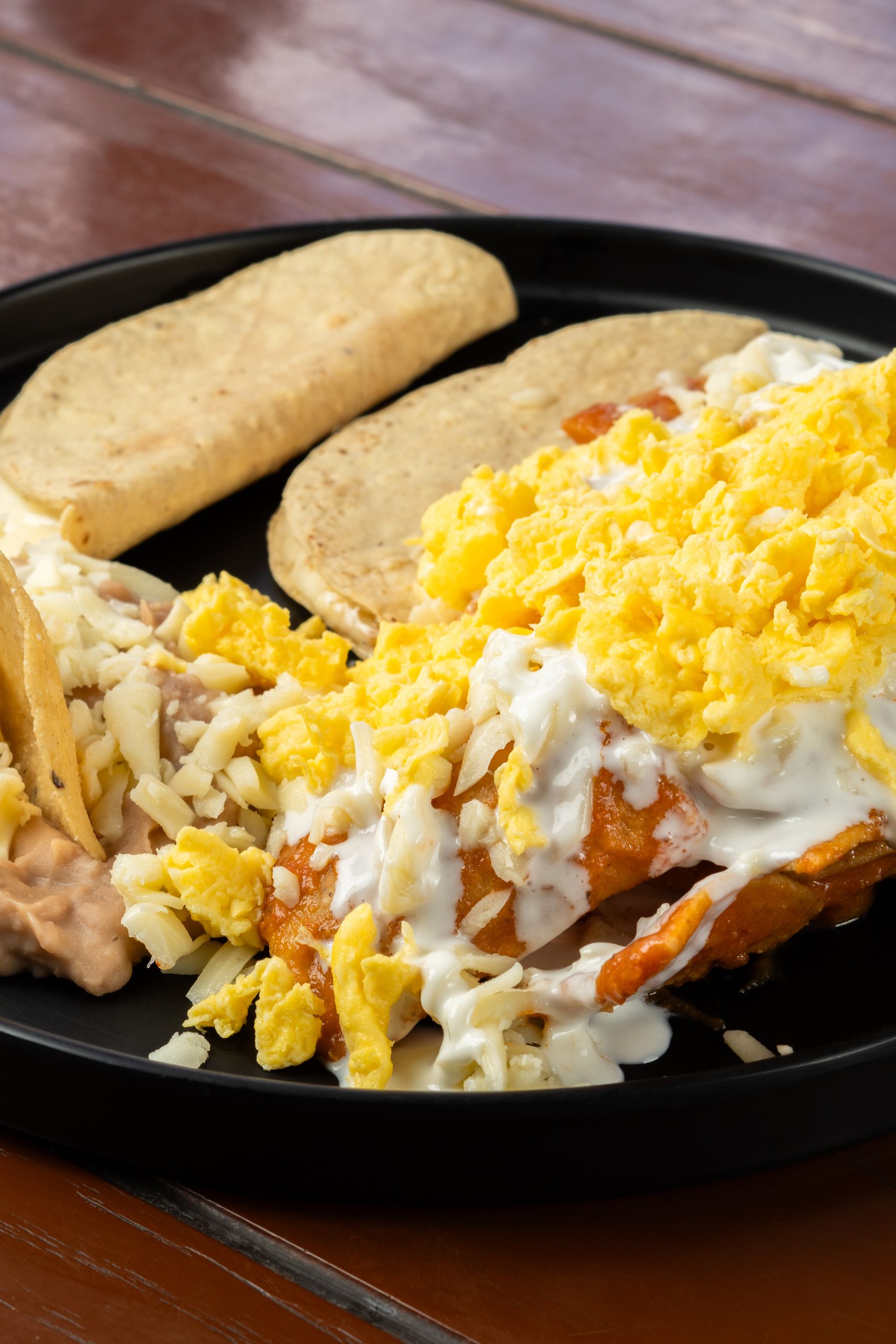 Mouth-watering Mexican breakfast platter featuring cheesy tacos and scrambled eggs, perfect for food photography.