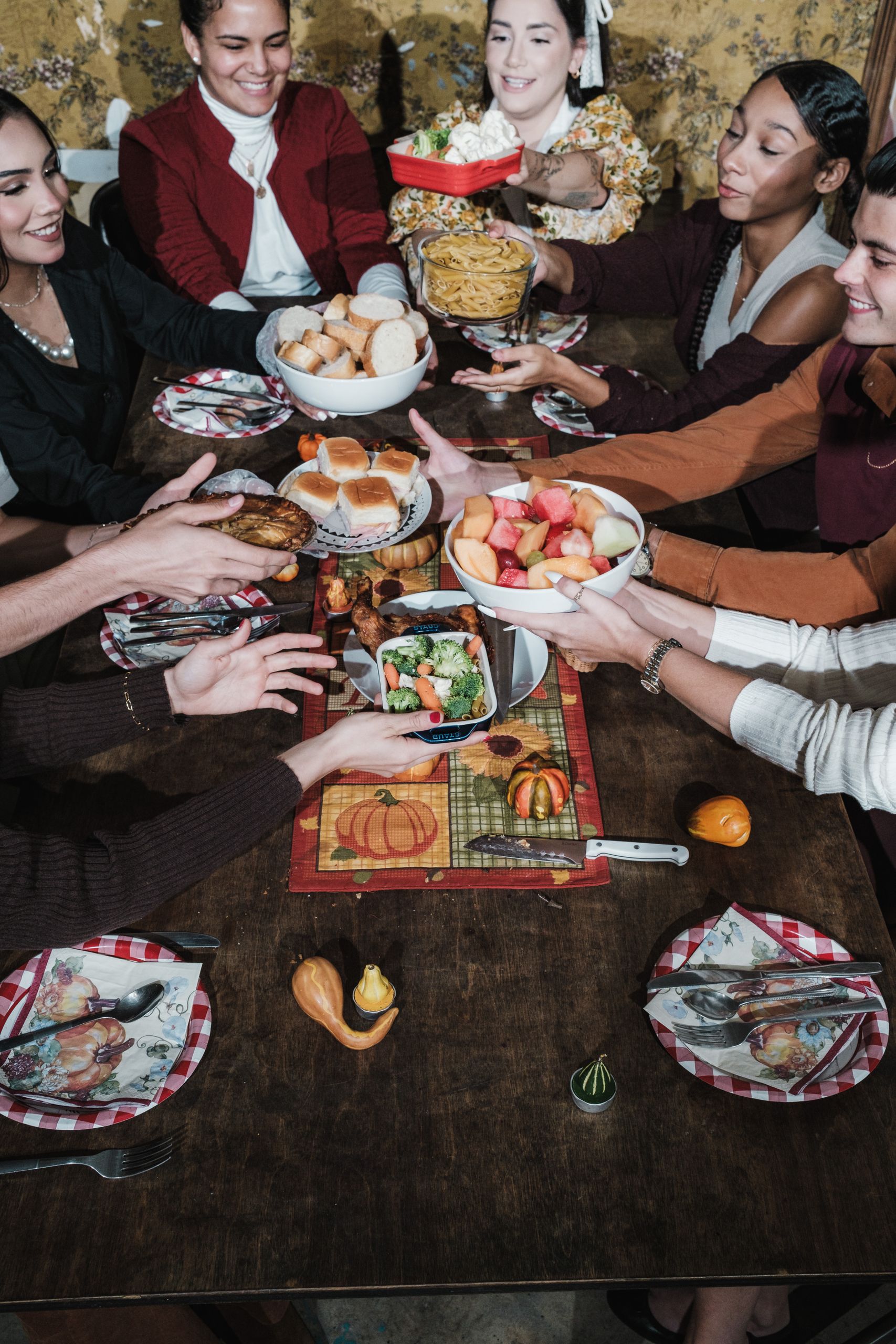 Friends sharing a festive meal around a table, celebrating Thanksgiving with joy and togetherness.