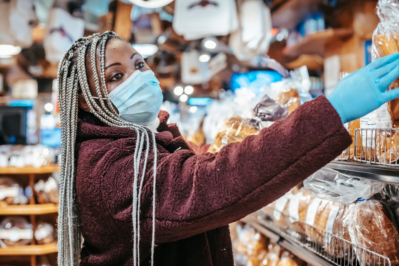 black-woman-shopping-in-supermarket-with-different-bread-