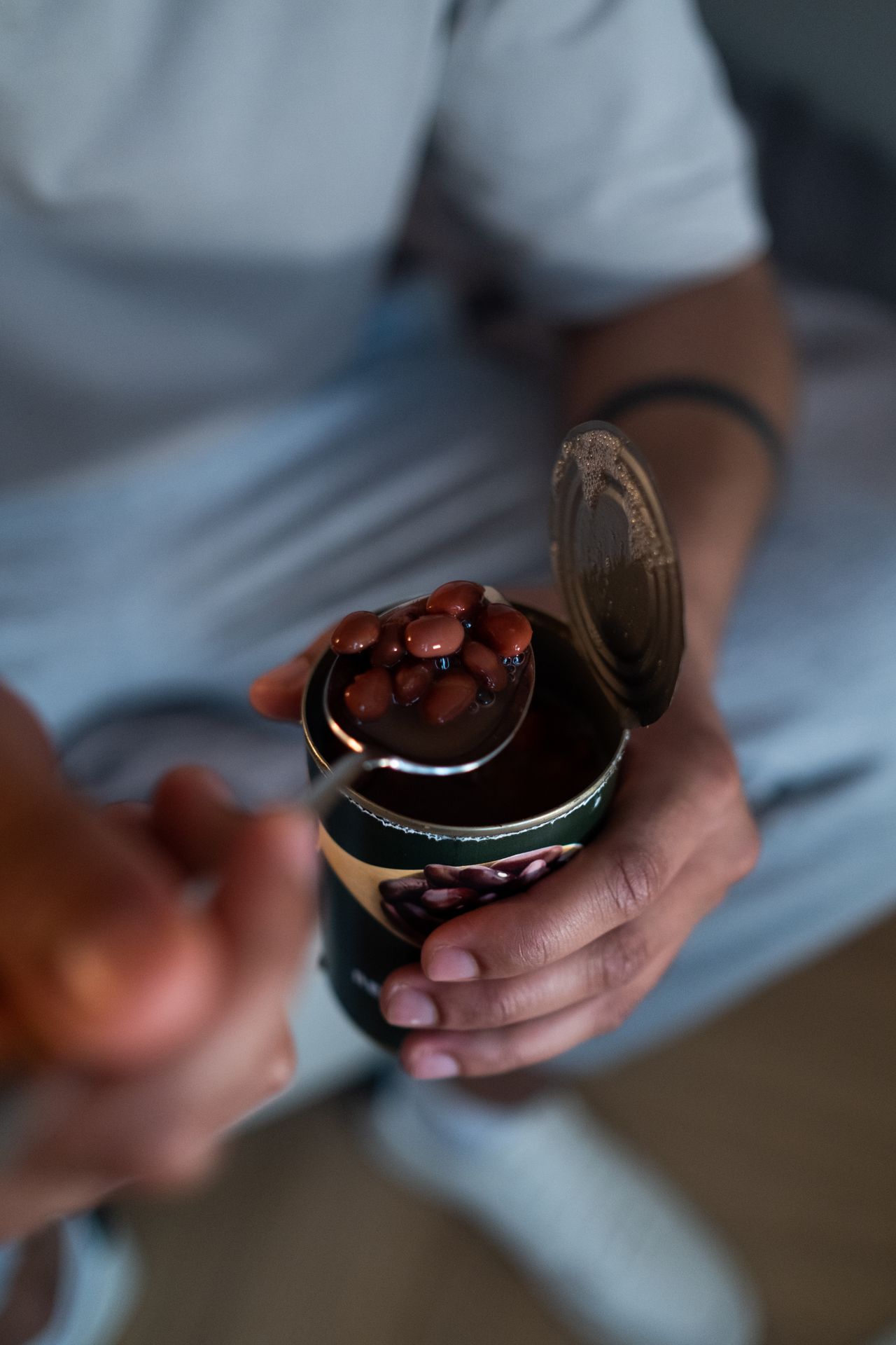 person-holding-canned-beans-