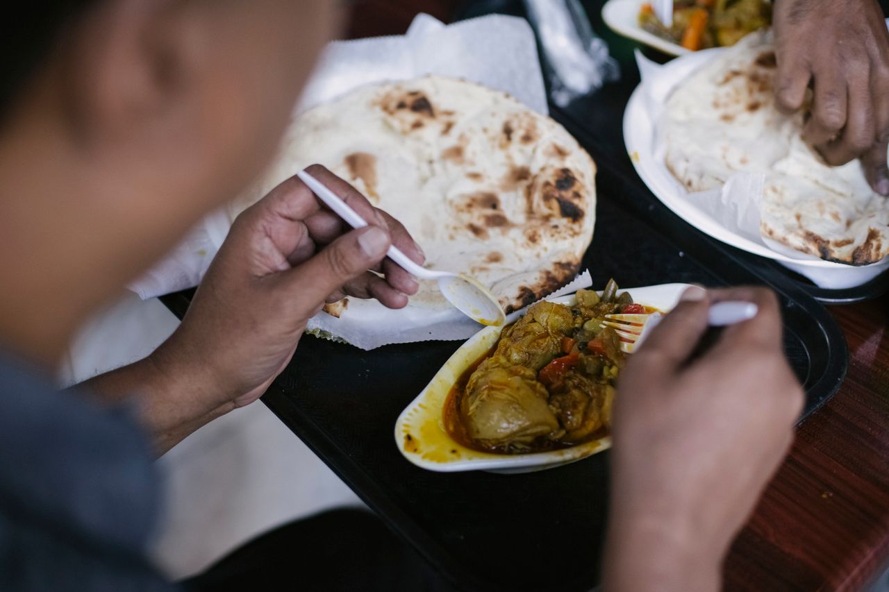 person-eating-pita-and-meat-for-lunch-