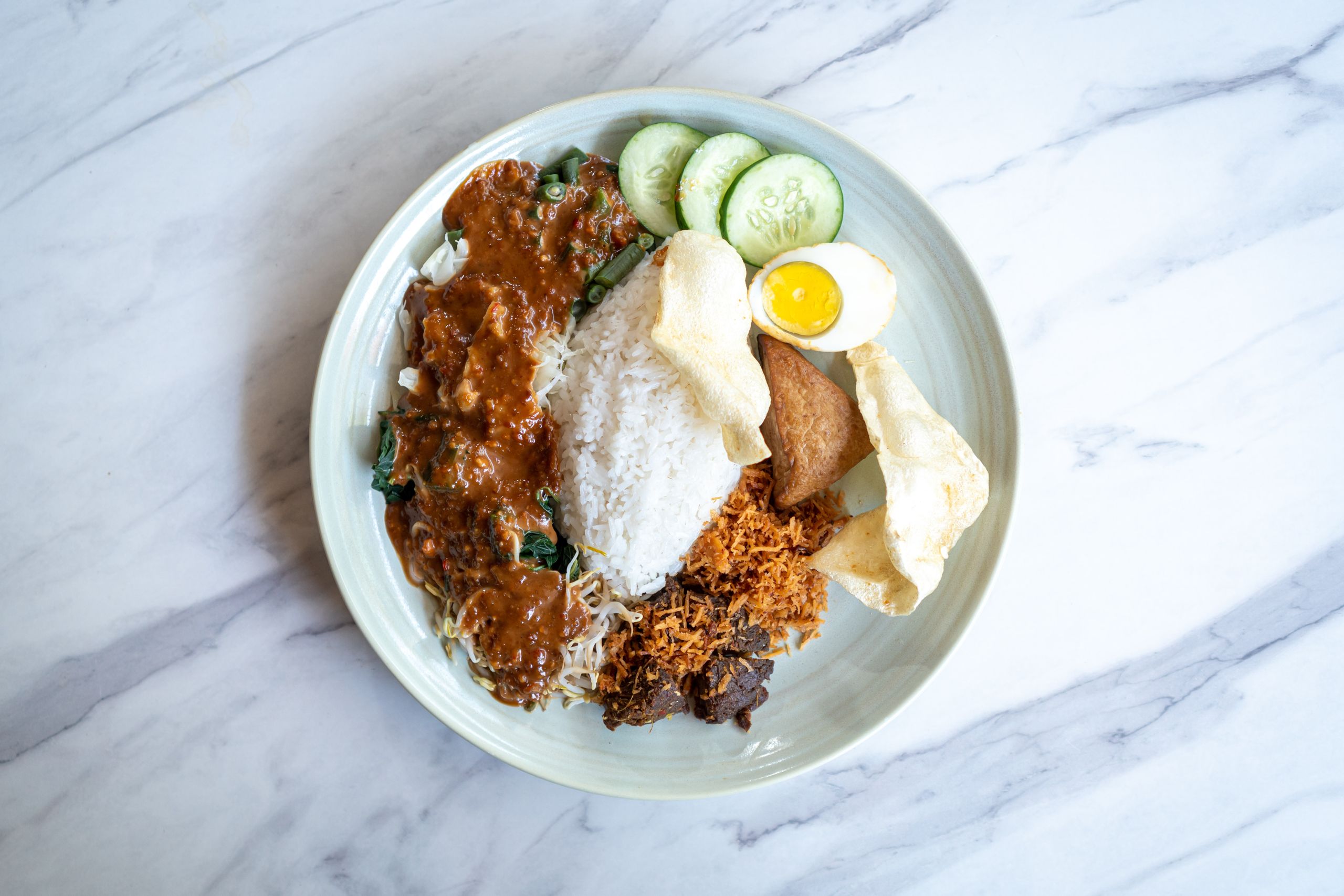 Top-view of Nasi Pecel, a traditional Indonesian dish with rice and vegetables from Bali.